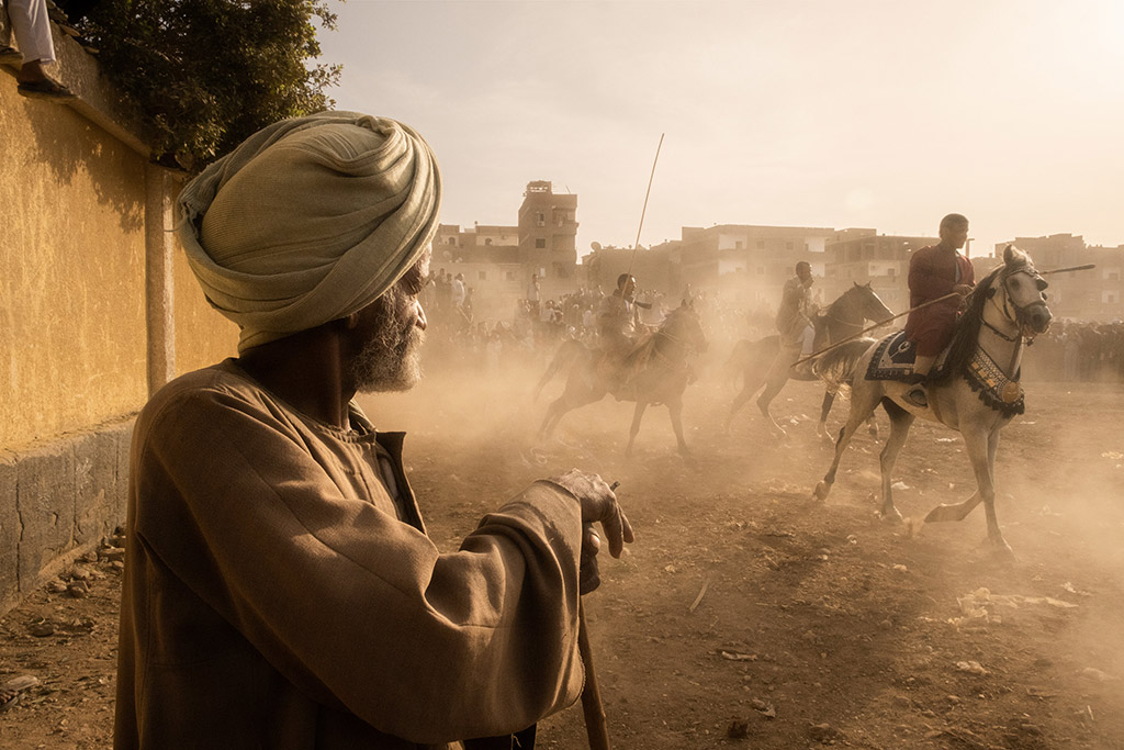 street portrait of a man looking at dust being kicked up by the horses’ hooves Amateur Photographer of the Year 2023 winners